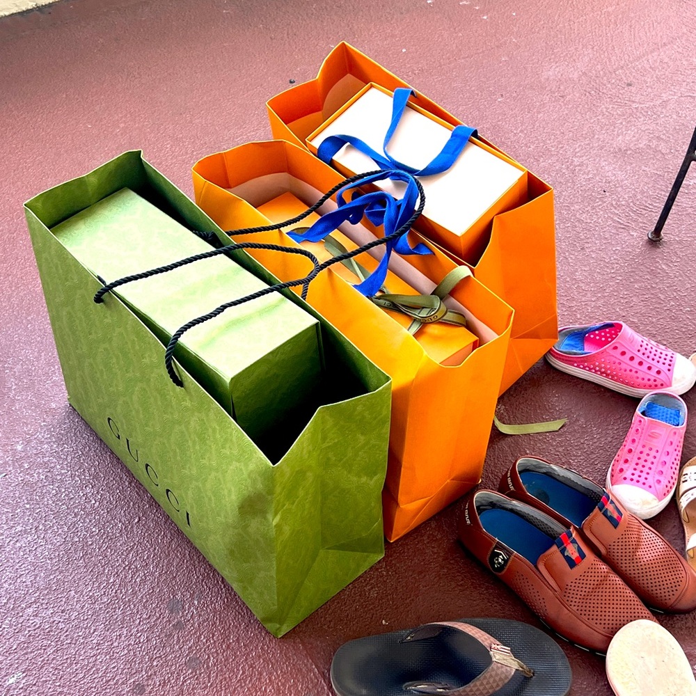 Louis Vuitton and Guchi shooing bags and boxes.